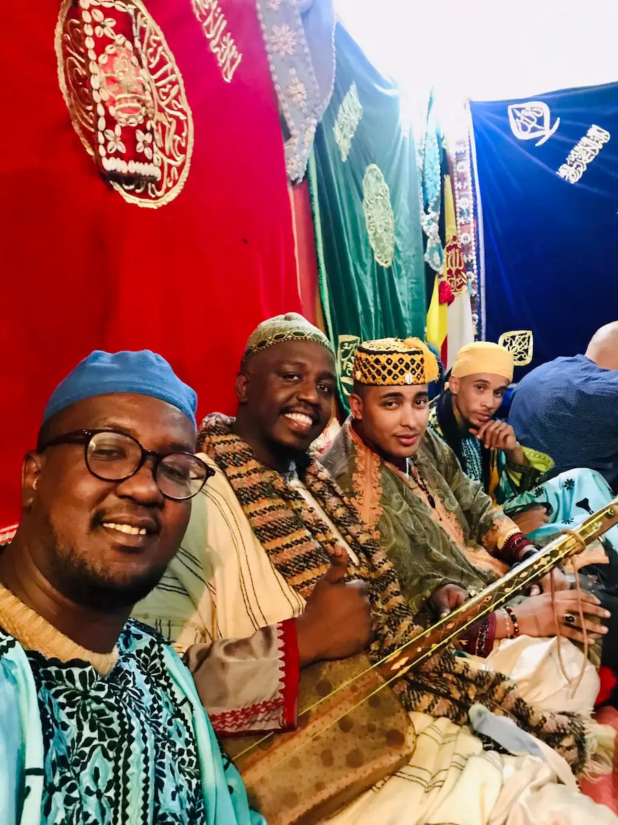 Hamza Guinea performing during the El Aada procession — the raw, physical soul of Gnawa